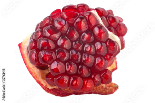 Purified piece of the fruit pomegranate isolated on white background. Red seeds.