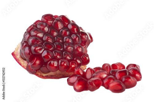 Purified piece of the fruit pomegranate and red seeds isolated on a white background
