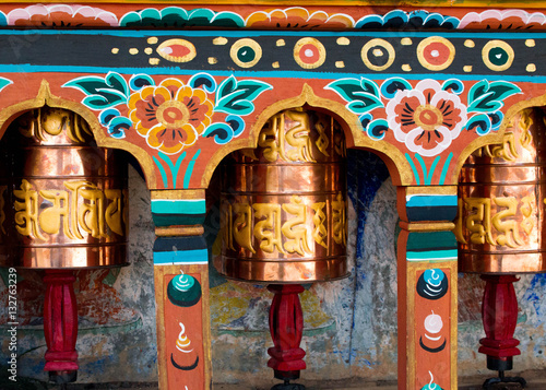 Billede på lærred Bhutan copper and golden prayer bell wheel with wooden traditional paintings in