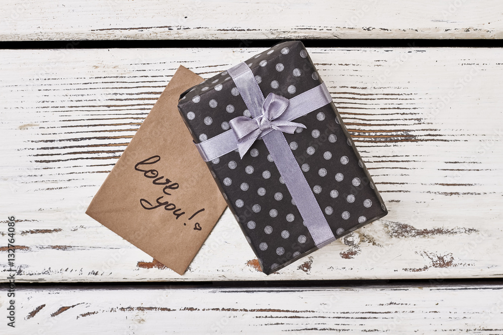 Fototapeta premium Love you card and gift. Black spotted box with bow. Express your feelings more often.
