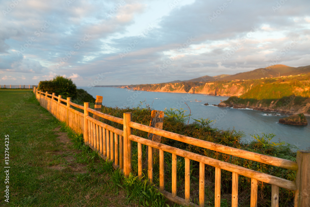 Fragment of a rural fence at sunset