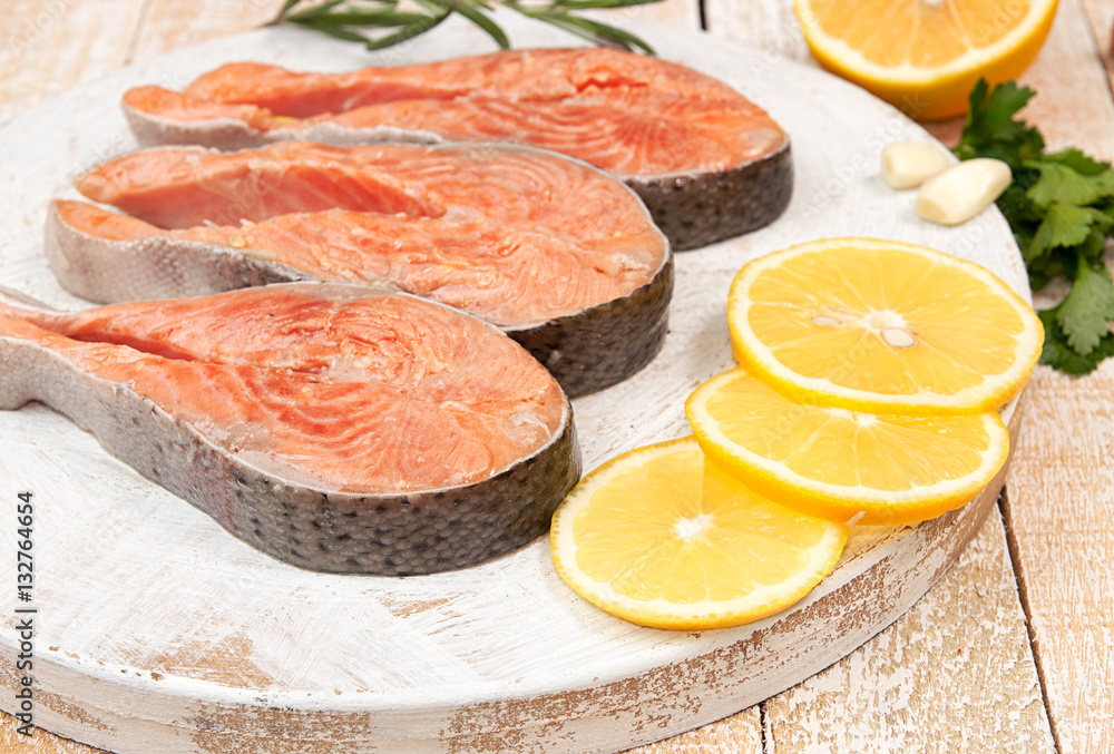 Raw marinated trout fillet on wooden cutting board. Raw marinated trout fillet on wooden cutting board.