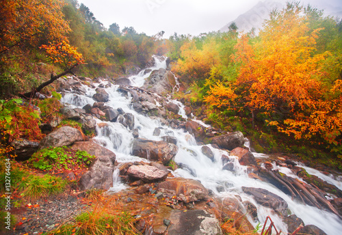 beautiful cascade waterfall in autumn forest