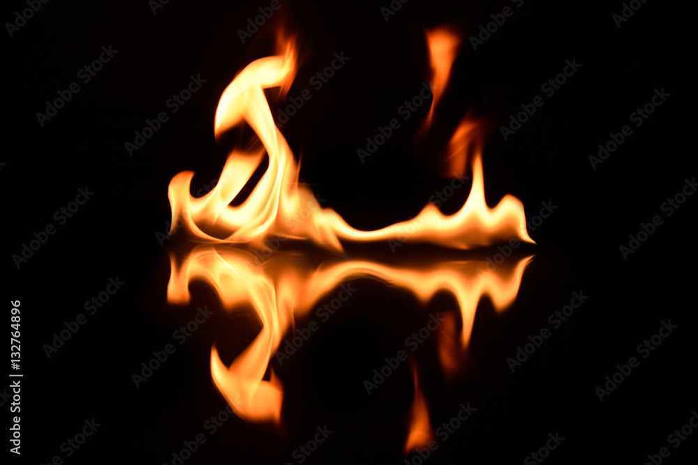 Fototapeta premium flames on a black background with mirror reflection