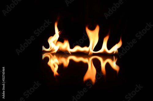  flames on a black background with mirror reflection