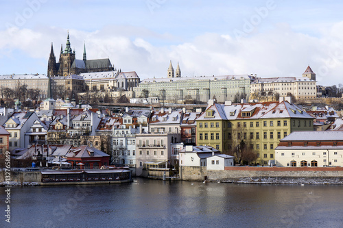 Snowy freeze Prague Lesser Town with gothic Castle above River Vltava, Czech republic photo