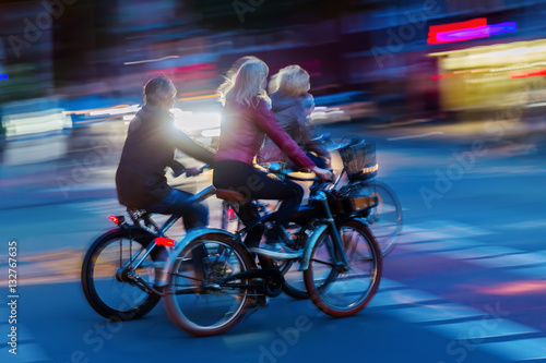 group of bicycle riders at night