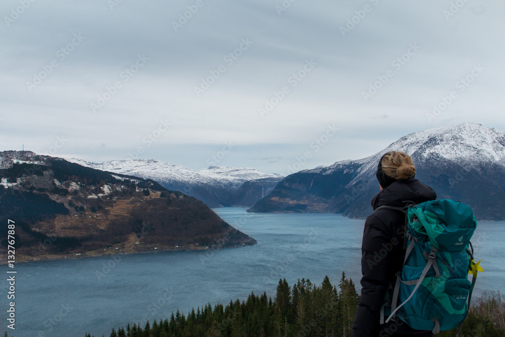 Norway hardanger fjord blonde woman looking from the mountain in winter Norway hardanger fjord blonde woman looking from the mountain in winter