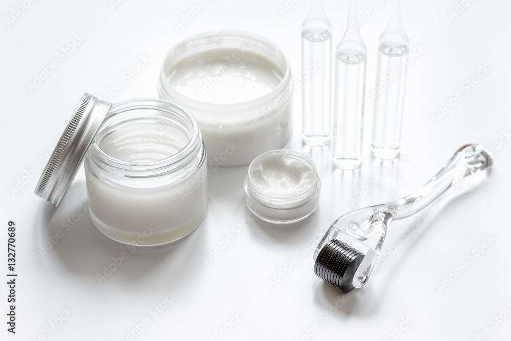 concept beautician desktop with mezoroller - mesotherapy on white background concept beautician desktop with mezoroller - mesotherapy on white background