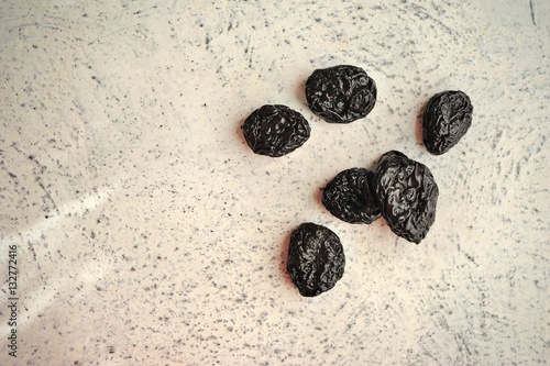 dried prunes on a textured background