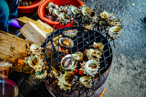 Grilled turban shells in seafood shop near Seopjikoji, Jeju isla photo