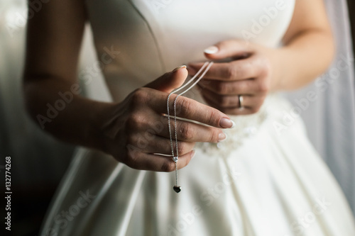 Bride and jewelry in hands