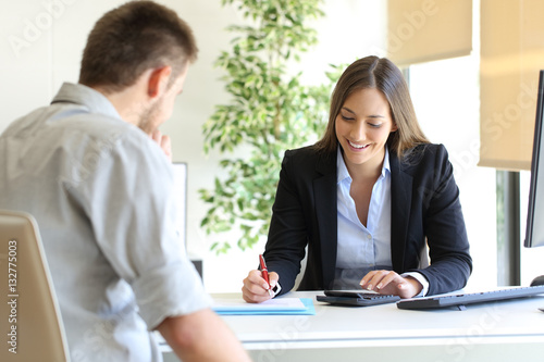 Insurance agent and customer calculating budget
