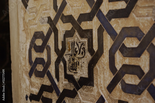 Fine decorations on the walls of Alhambra palace.