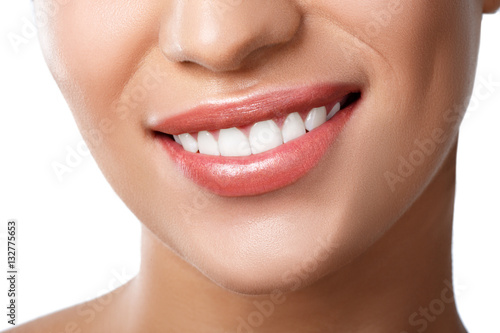 Close up of beautiful wide smile of young fresh woman with great healthy white teeth. Isolated over white background
