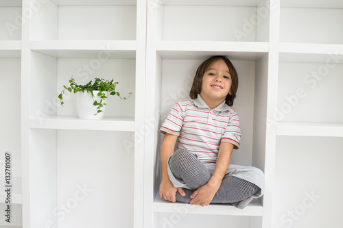 Child in shelf inside living room