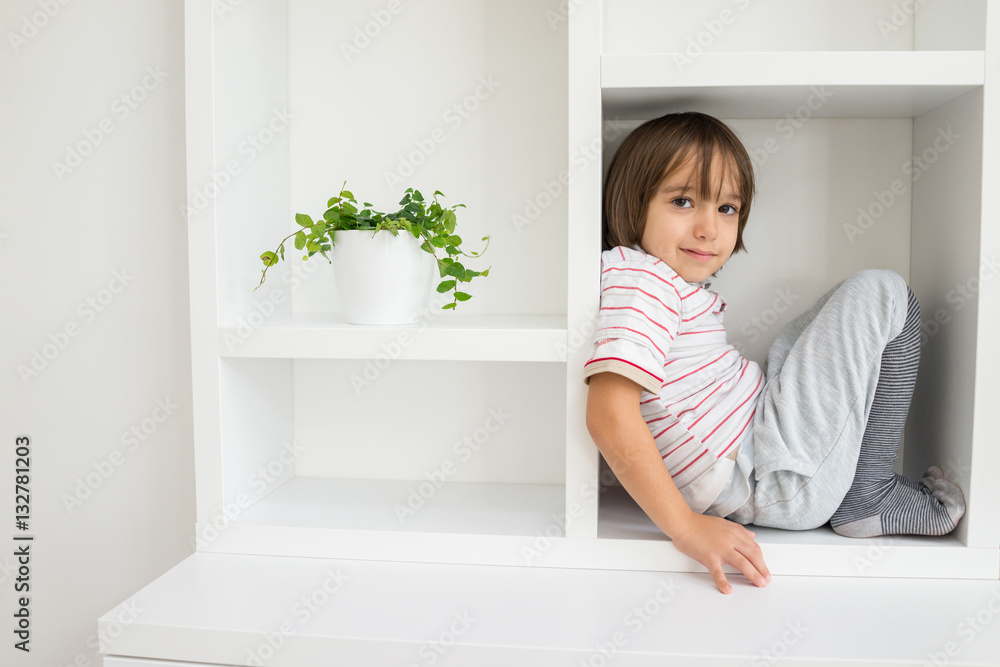 Child in shelf inside living room Child in shelf inside living room