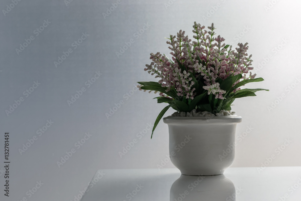 Vase of decorative flowers on the white table Vase of decorative flowers on the white table