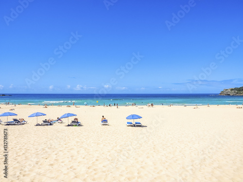Beautiful Landscape in Bondi Beach, Australia. Blue Sky, White Sand, and Sunbathers.