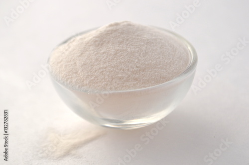 Xanthan gum - a white powder of plant origin for gluten free baking and cooking, closeup on white background
