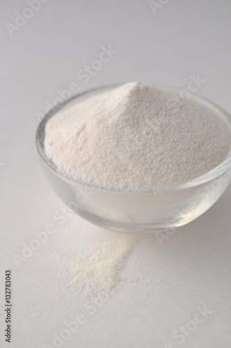 Xanthan gum - a white powder of plant origin for gluten free baking and cooking, closeup on white background
 photo