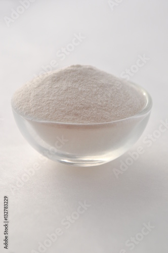 Xanthan gum - a white powder of plant origin for gluten free baking and cooking, closeup on white background 