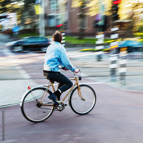 bicycle rider in city traffic in motion blur