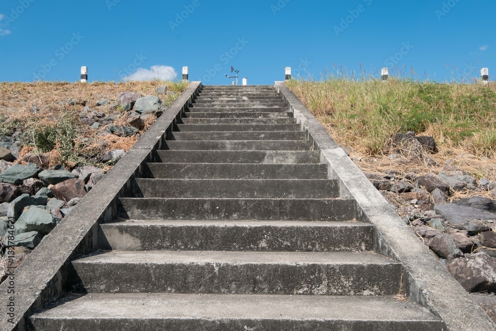 Dam up the cement stairs with blue sky