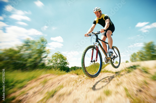 Fototapeta Naklejka Na Ścianę i Meble -  Young Man Riding His Mountain Bike