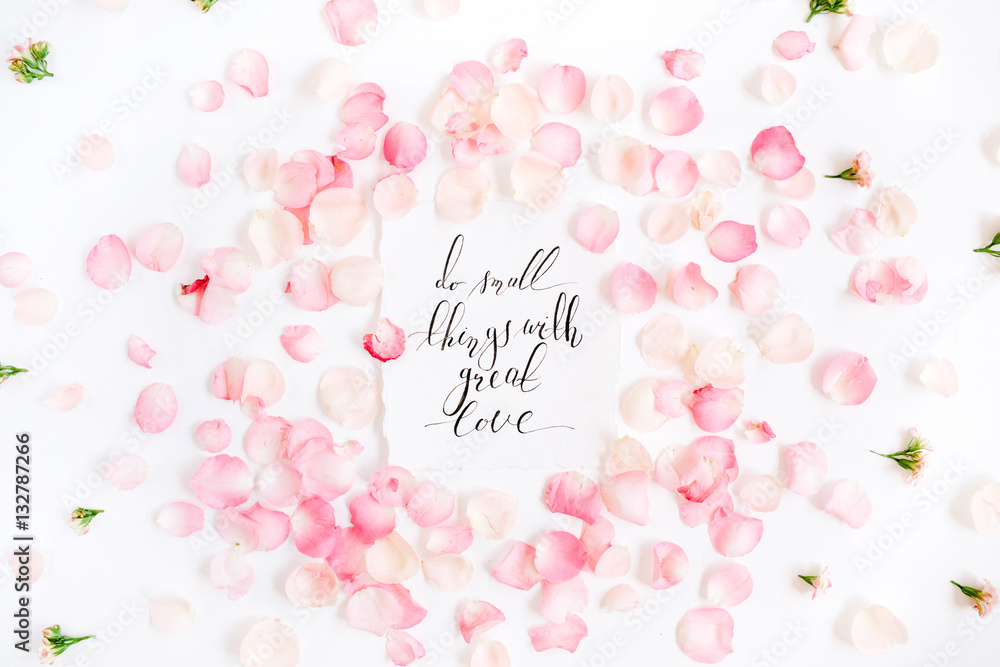 Do small things with great love. Inspirational quote made with calligraphy and floral pattern with pink rose petals. Flat lay, top view