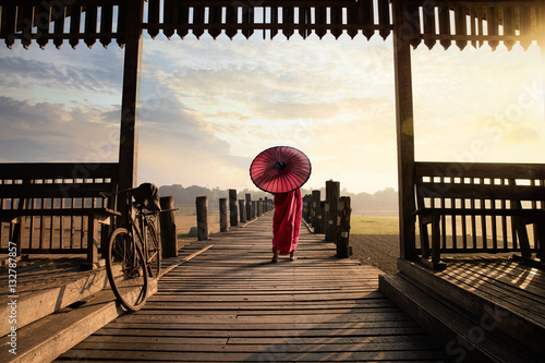 Monk walk on the wooded bridge, U Bein Bridge, Mandalay Myanmar photo