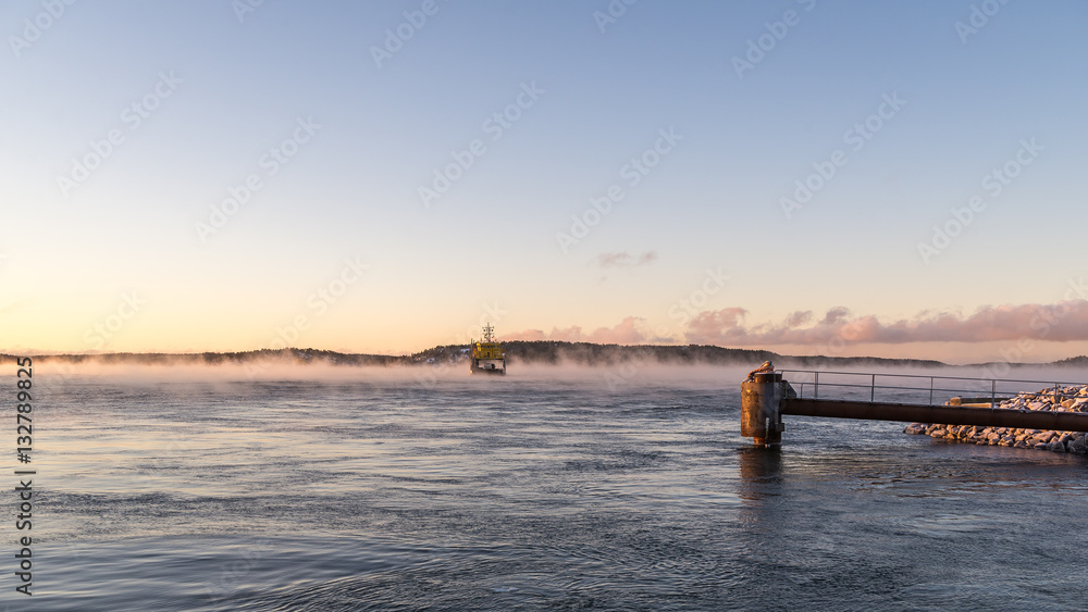 Ferry boats in misty winter morning