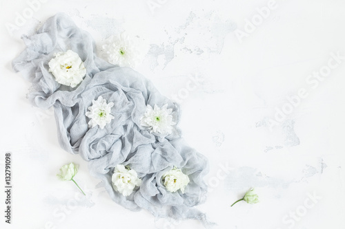 Composition with white flowers on gray background. Flat lay, top view