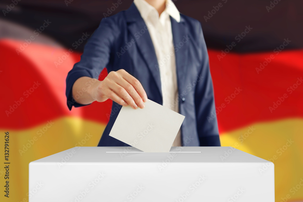 Voting. Woman putting a ballot into a voting box with German flag on background. Voting. Woman putting a ballot into a voting box with German flag on background.