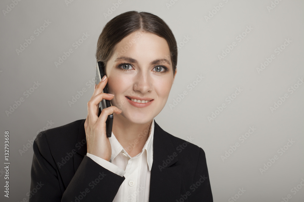 Business woman on the phone isolated over a grey background Business woman on the phone isolated over a grey background