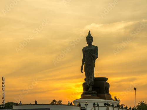 Grand walking buddha statue with warm tone