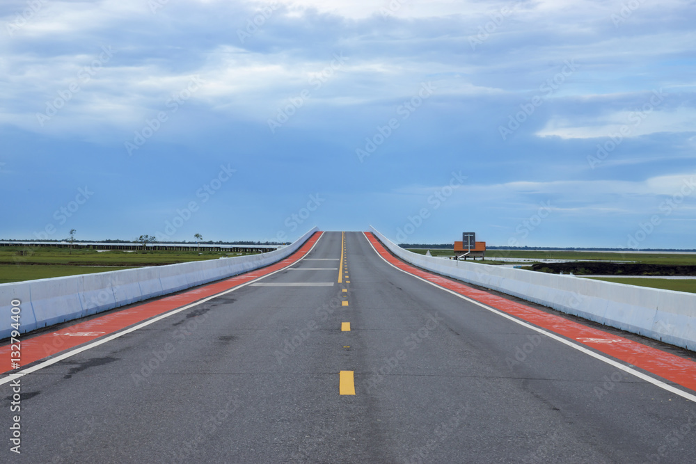 Fototapeta premium Empty road and the yellow traffic lines