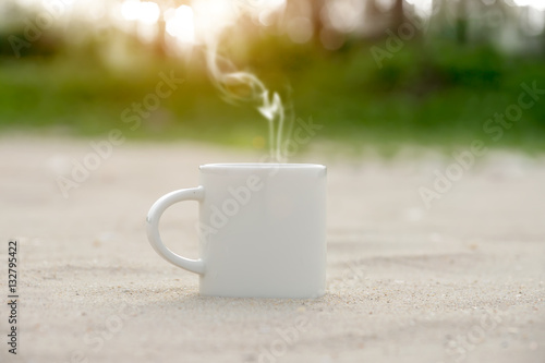 White coffee mug on the beach.