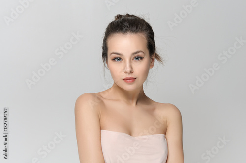 Girl with bared shoulders and gathered hair