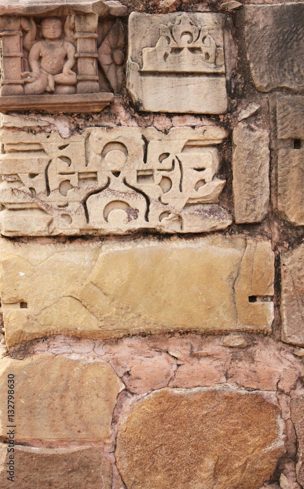 Stone wall and human sculpture at temple, Khajuraho, India