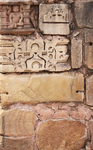 Stone wall and human sculpture at temple, Khajuraho, India