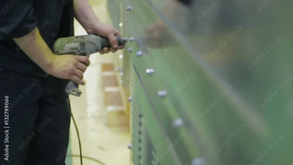 Worker screwing fasteners at industrial factory. Close up. HD. Worker screwing fasteners at industrial factory. Close up. HD.