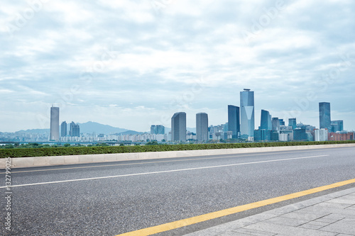 modern buildings in seoul from empty road in cloud sky