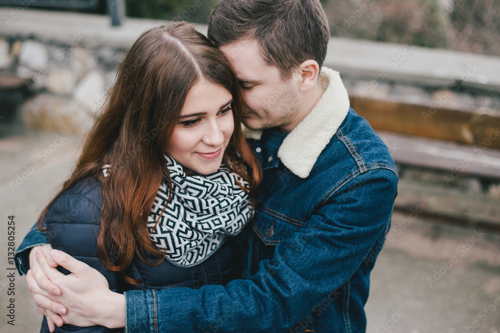 Young couple in love posing outdoors, hug and kiss Young couple in love posing outdoors, hug and kiss