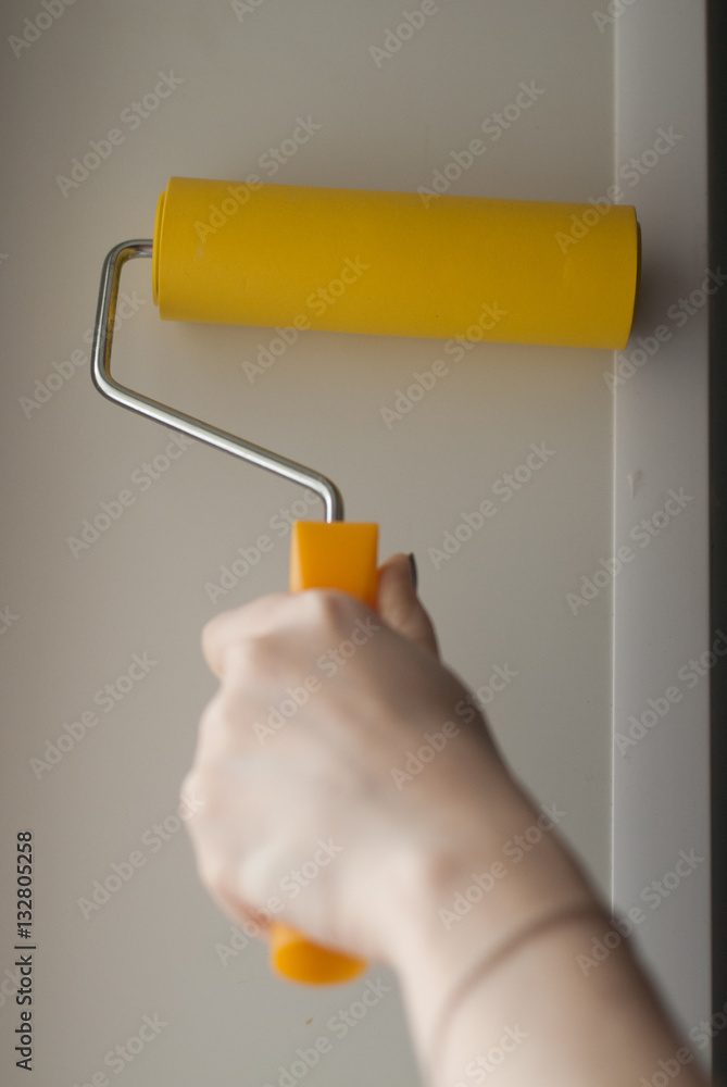 hand with yellow paint rollers, feminine touch, hand with yellow paint rollers, feminine touch,
