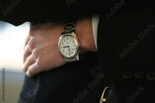 concept of saving time: closeup hand of businessman with a watch