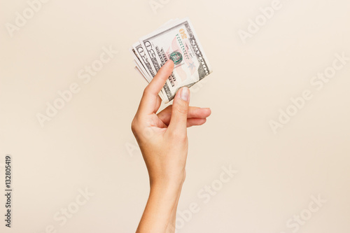 Woman's hand with money on a light background