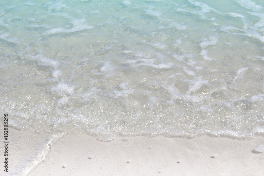 Shallow azure seawater on the beach close up. Background Shallow azure seawater on the beach close up. Background