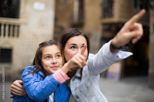 Positive mother pointing to daughter new sight