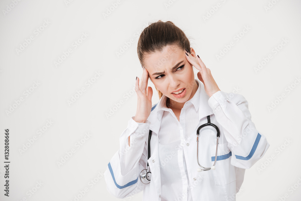 Sad stressed young woman doctor having headache Sad stressed young woman doctor having headache